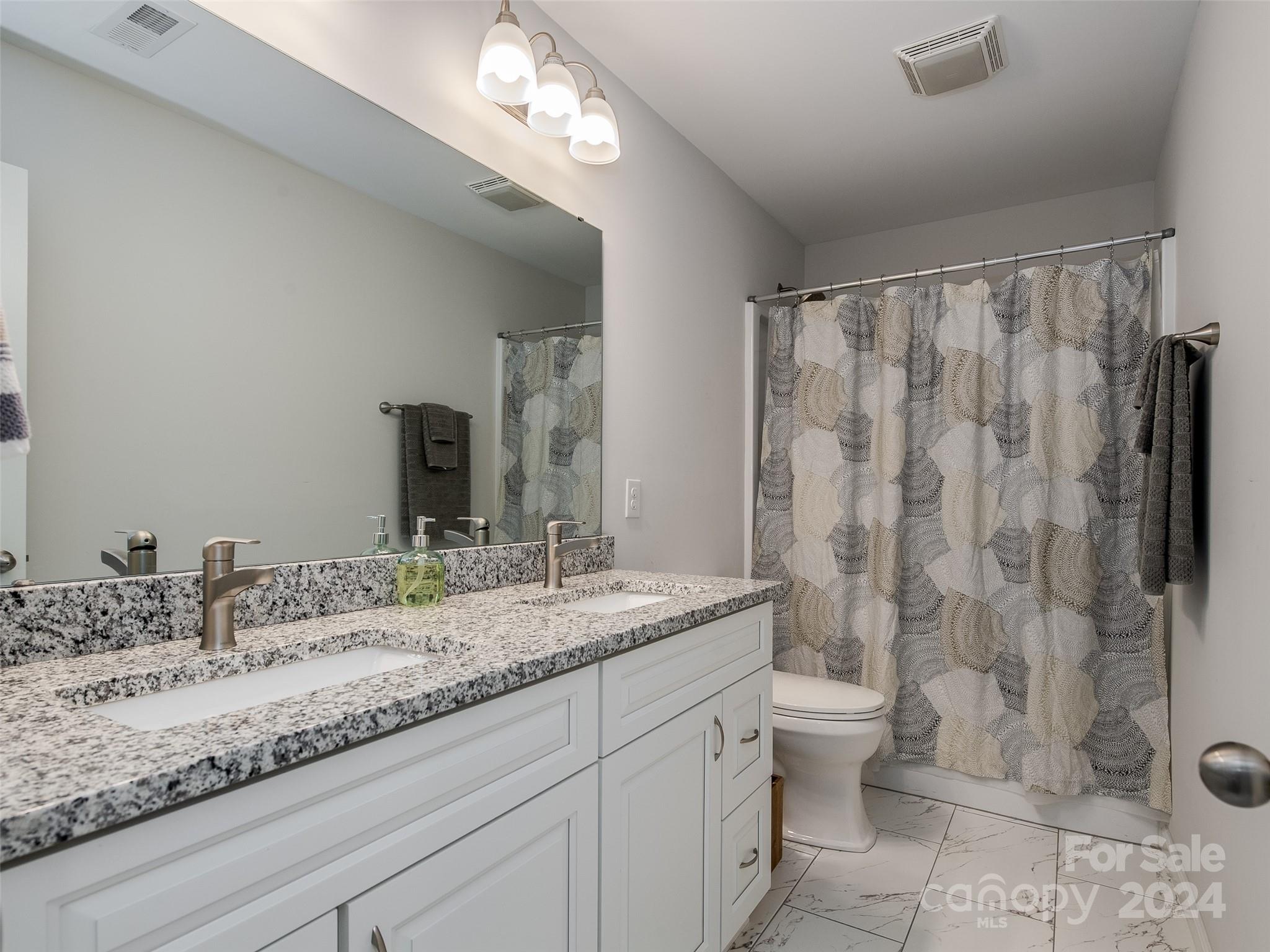 1122 Rhyne Road Charlotte, NC 28214 - Photo 18 of 22 a bathroom with a granite countertop sink toilet and shower
