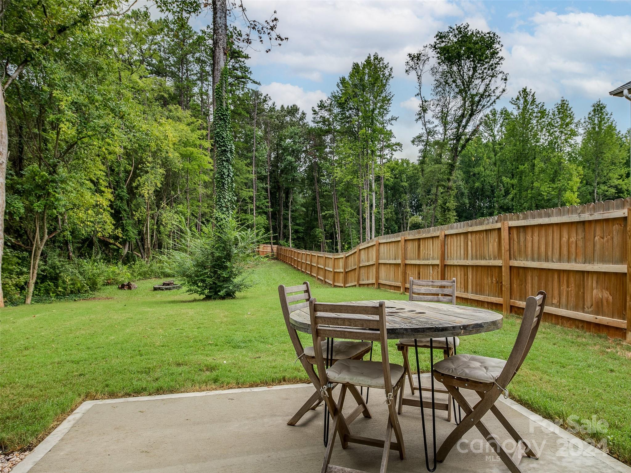 1122 Rhyne Road Charlotte, NC 28214 - Photo 19 of 22 a patio with a table and chairs