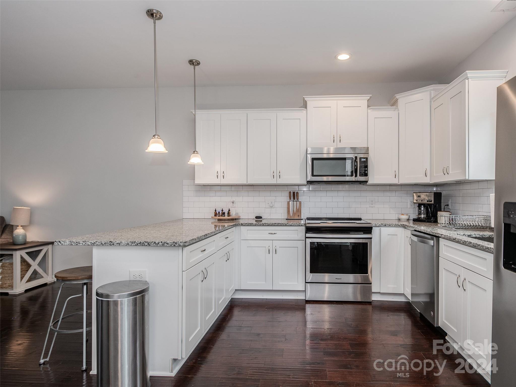 1122 Rhyne Road Charlotte, NC 28214 - Photo 4 of 22 a kitchen with stainless steel appliances granite countertop a stove sink and cabinets