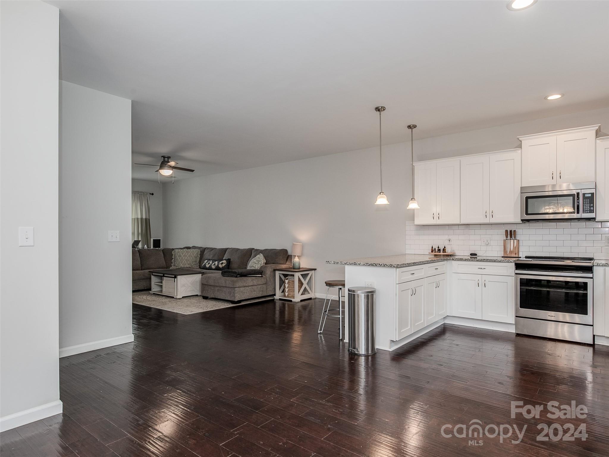 1122 Rhyne Road Charlotte, NC 28214 - Photo 5 of 22 a kitchen with a white cabinets and stove top oven