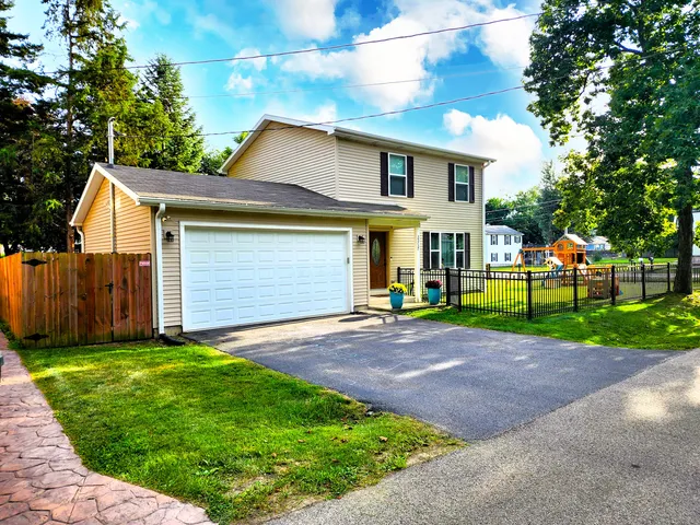 a view of a yard in front view of a house