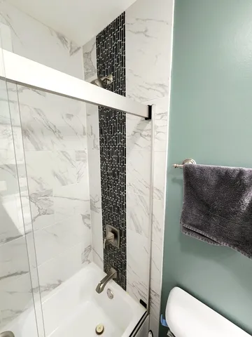 a bathroom with a toilet and shower