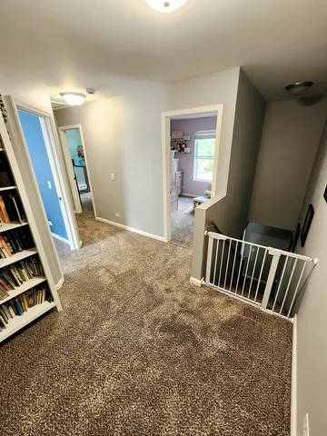 a view of an empty room and stairs