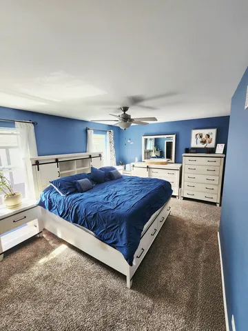 a spacious bedroom with a bed and window