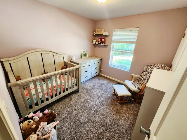 a living room with furniture stairs and a window