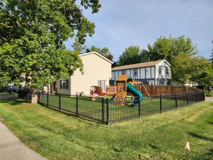 a view of a garden with a bench and trees