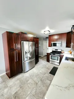 a kitchen with stainless steel appliances a refrigerator and a stove top oven