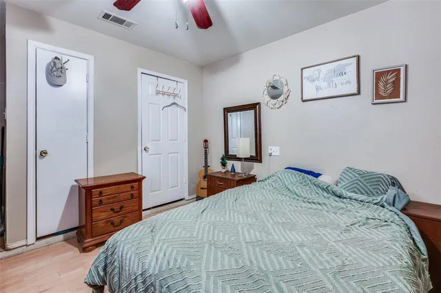 a bedroom with a bed and a dresser in it