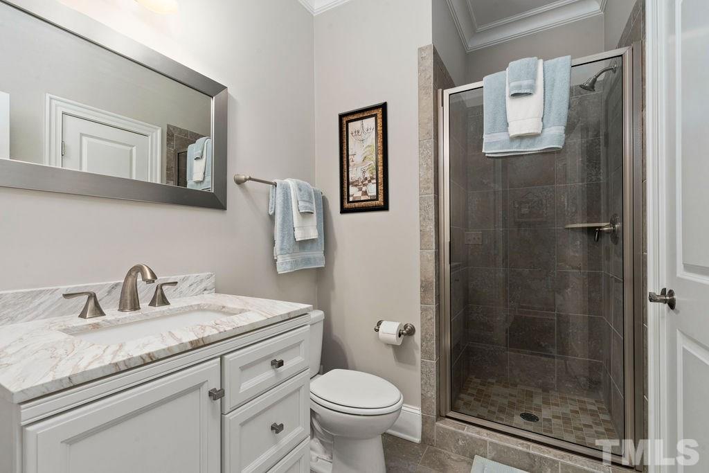 1217 Harrison Ridge Road Wake Forest, NC 27587 - Photo 12 of 30 a bathroom with a granite countertop toilet a sink and a mirror