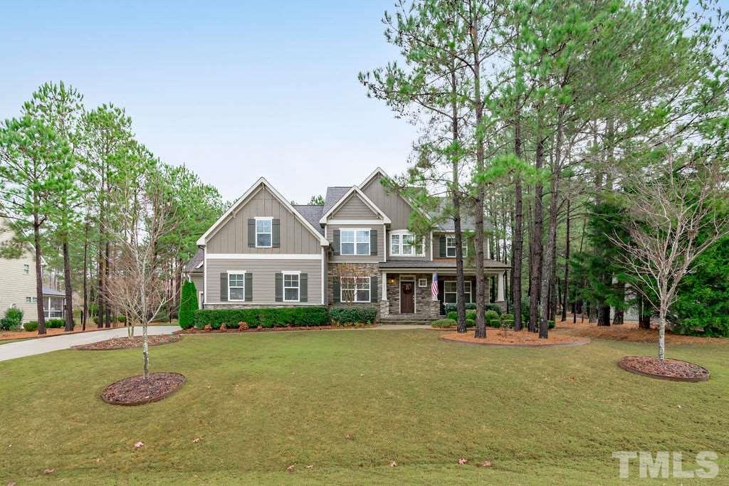 1217 Harrison Ridge Road Wake Forest, NC 27587 - Photo 2 of 30 a front view of a house with a yard garage and tree