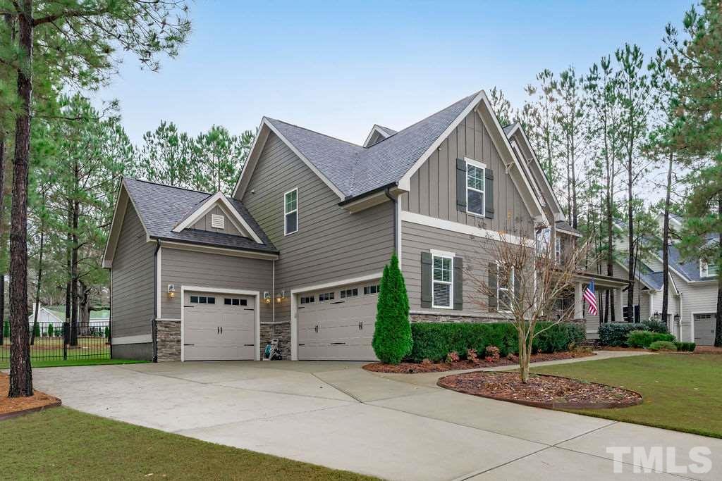 1217 Harrison Ridge Road Wake Forest, NC 27587 - Photo 30 of 30 a front view of a house with a garden and trees