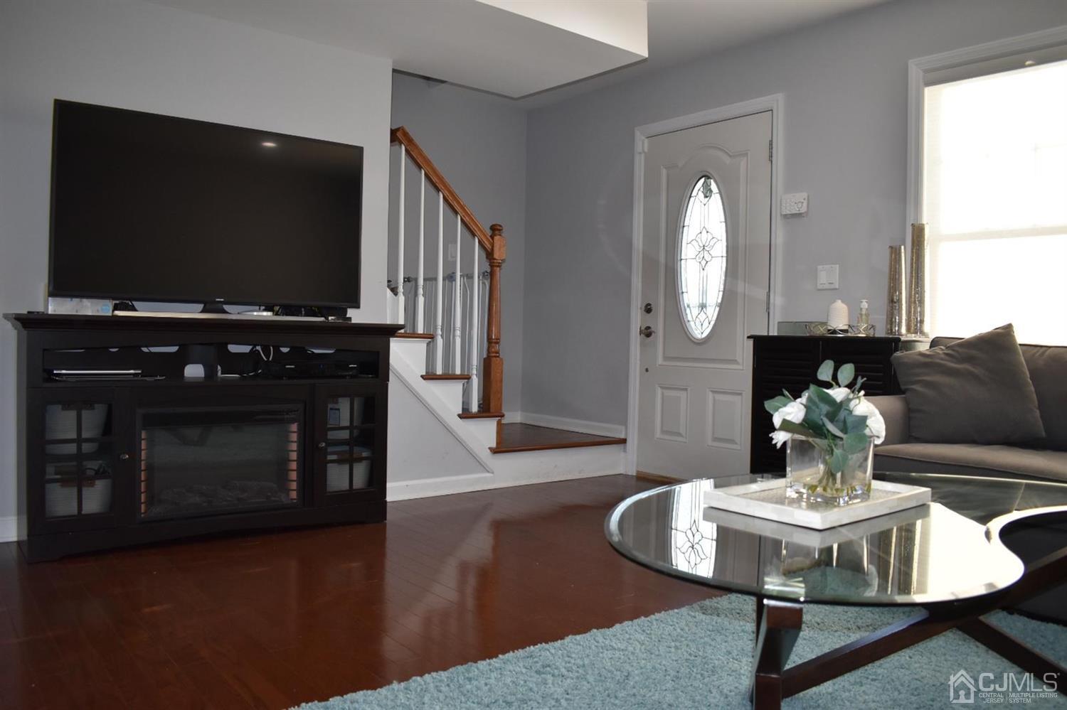 41 Caldwell Road Edison, NJ 08817 - Photo 3 of 16 a living room with fireplace furniture and a flat screen tv