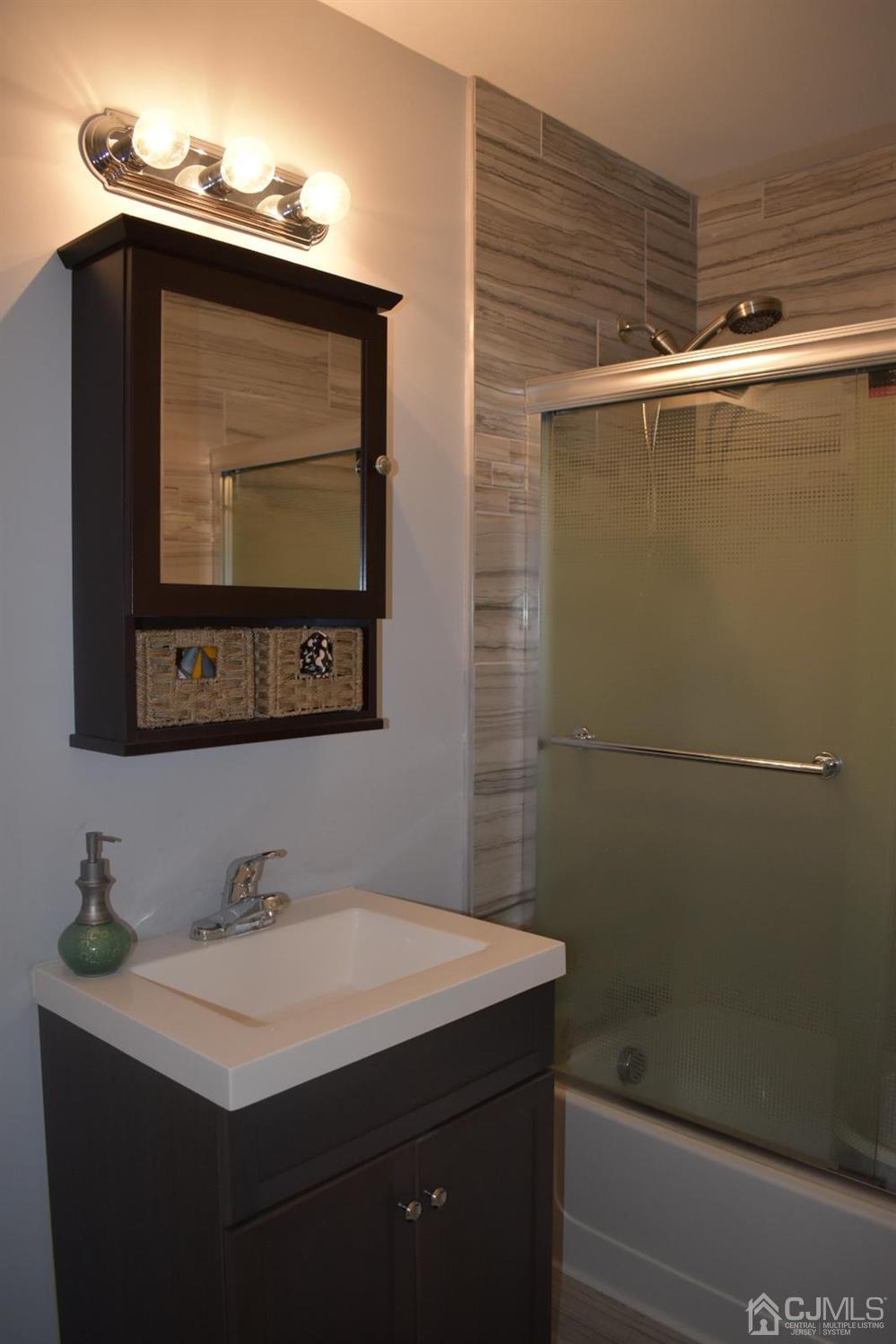 41 Caldwell Road Edison, NJ 08817 - Photo 10 of 16 a bathroom with a sink vanity and mirror