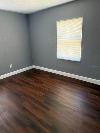 wooden floor in an empty room with a mirror