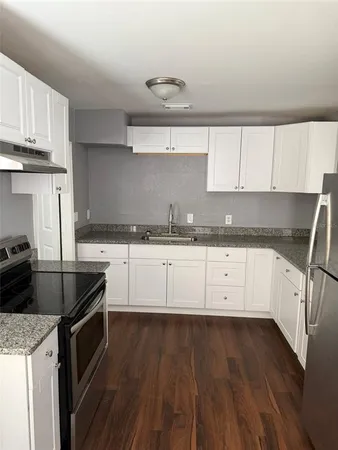 a kitchen with granite countertop white cabinets and a granite counter tops