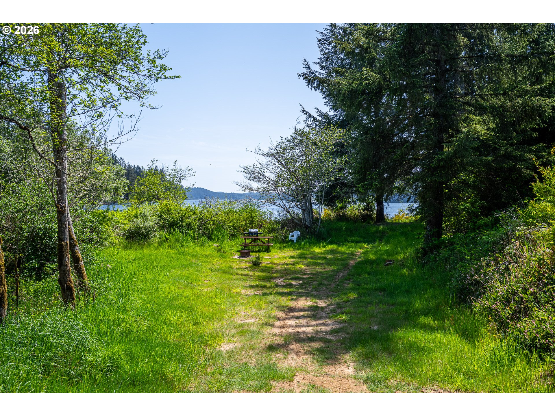 Clear Lake Road, Unit 7 Florence, OR 97439 - Photo 7 of 12 a grassy field with trees in the background