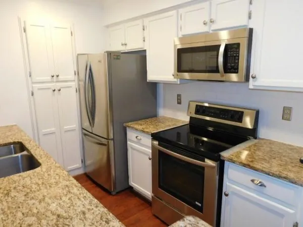 a kitchen with a refrigerator stove and microwave