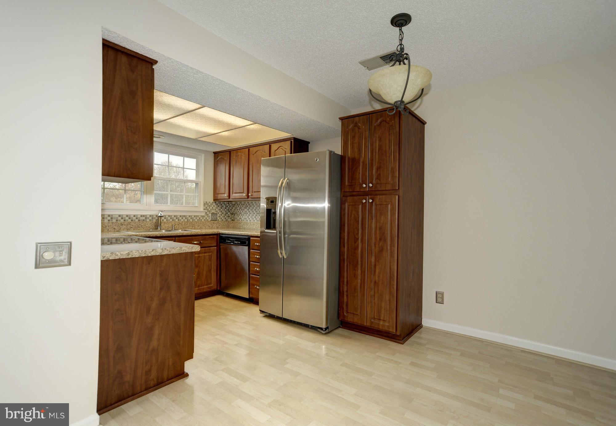 12000 Golf Ridge Court, Unit 352 Fairfax, VA 22033 - Photo 13 of 29 a kitchen with stainless steel appliances granite countertop a refrigerator and a sink