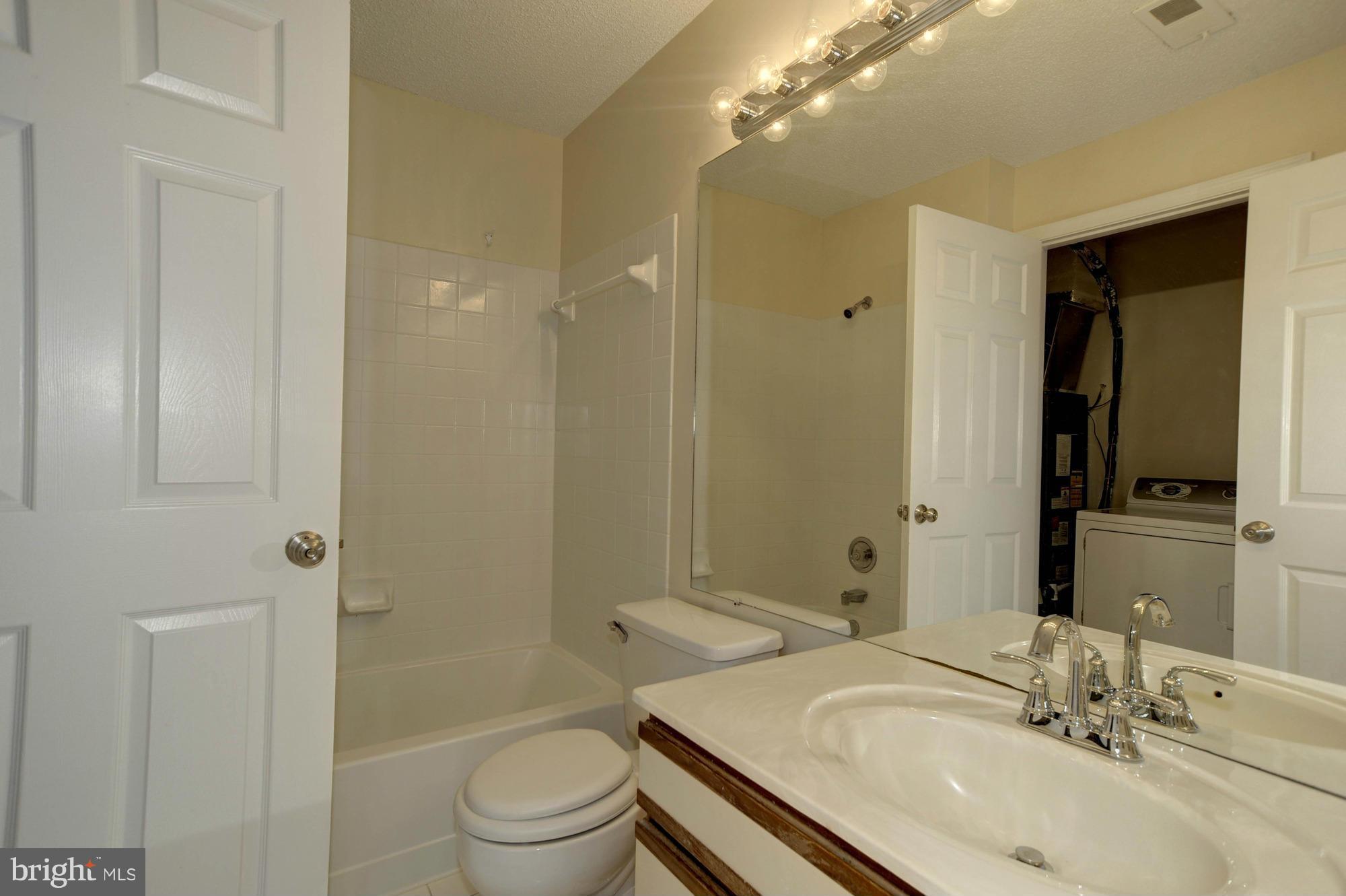 12000 Golf Ridge Court, Unit 352 Fairfax, VA 22033 - Photo 17 of 29 a bathroom with a sink a toilet and shower