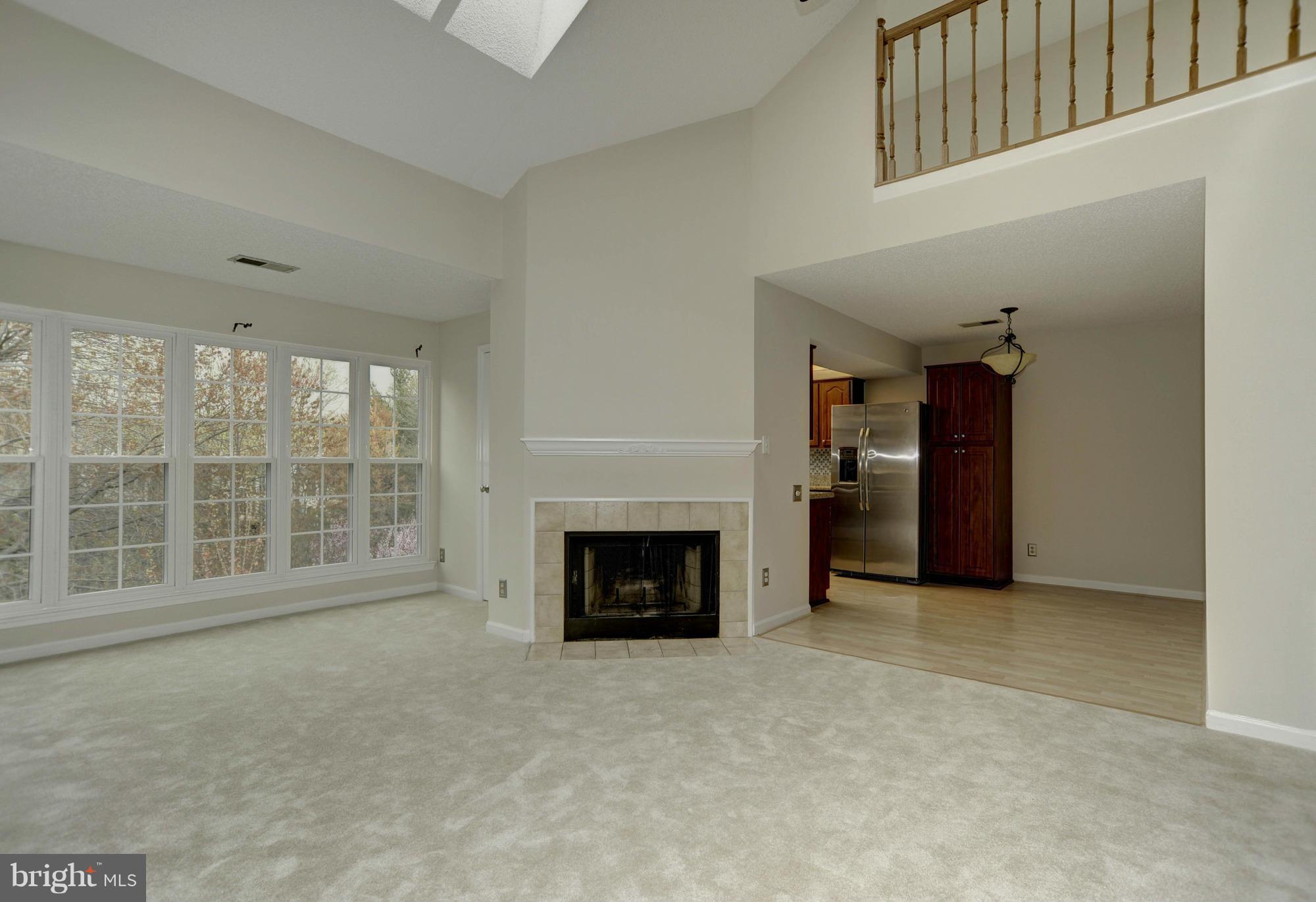 12000 Golf Ridge Court, Unit 352 Fairfax, VA 22033 - Photo 3 of 29 an empty room with furniture and a fireplace