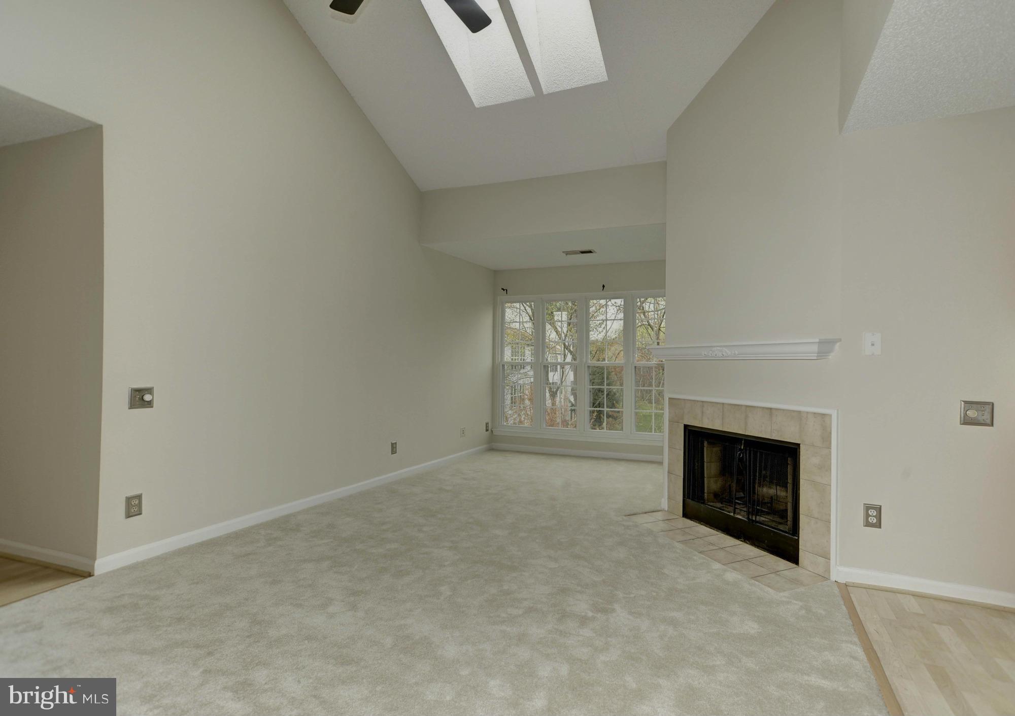 12000 Golf Ridge Court, Unit 352 Fairfax, VA 22033 - Photo 4 of 29 an empty room with windows and fireplace