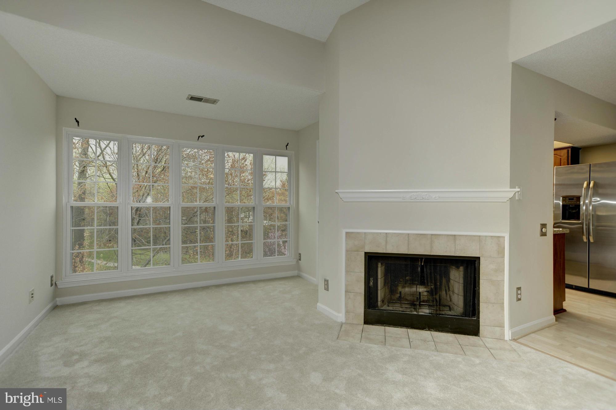 12000 Golf Ridge Court, Unit 352 Fairfax, VA 22033 - Photo 5 of 29 a view of an empty room with a fireplace and a window