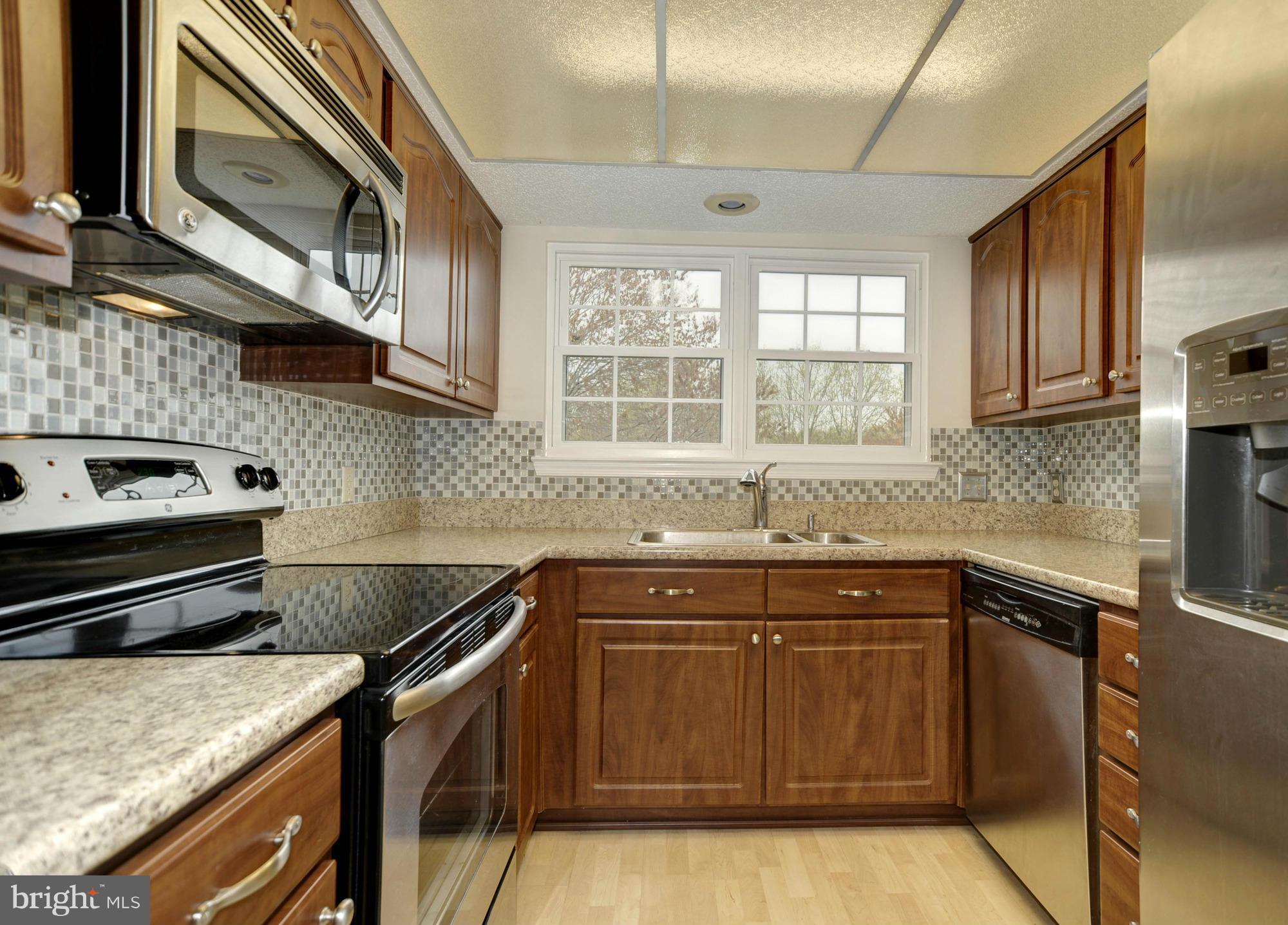 12000 Golf Ridge Court, Unit 352 Fairfax, VA 22033 - Photo 9 of 29 a kitchen with a sink and cabinets