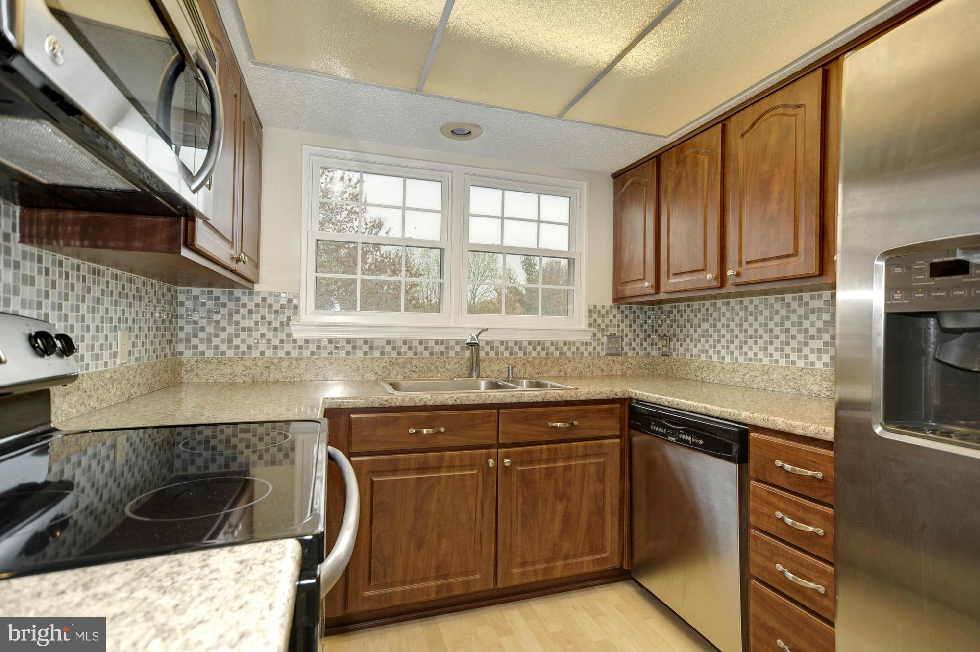 12000 Golf Ridge Court, Unit 352 Fairfax, VA 22033 - Photo 10 of 29 a kitchen with stainless steel appliances granite countertop a sink and cabinets