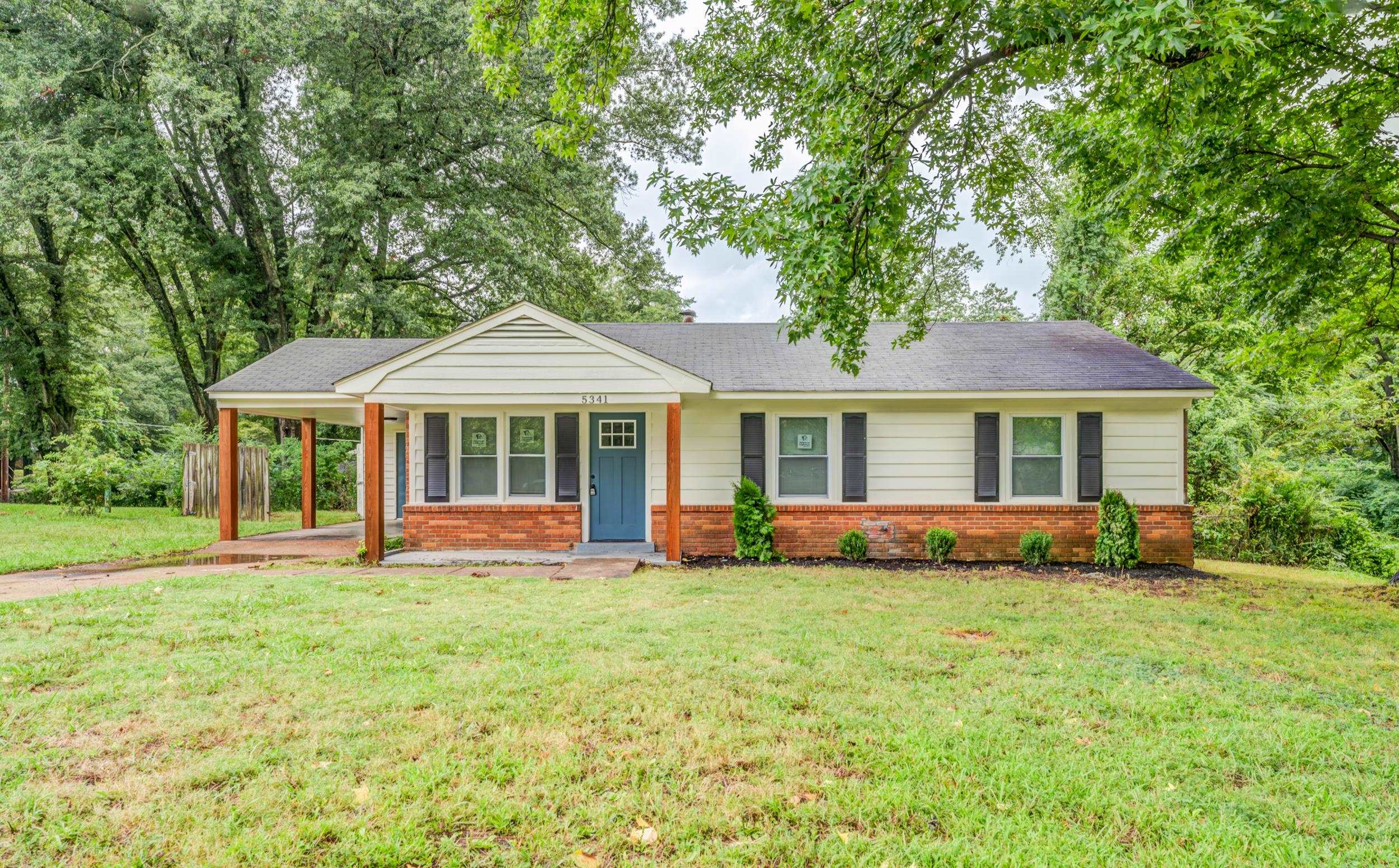 5341 Millbranch Road Memphis, TN 38116 - Photo 1 of 29 a front view of a house with a garden and porch