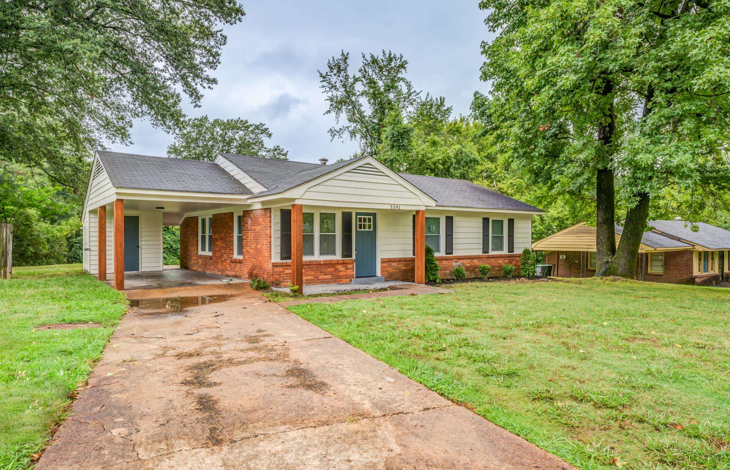 5341 Millbranch Road Memphis, TN 38116 - Photo 2 of 29 a front view of a house with a garden and porch