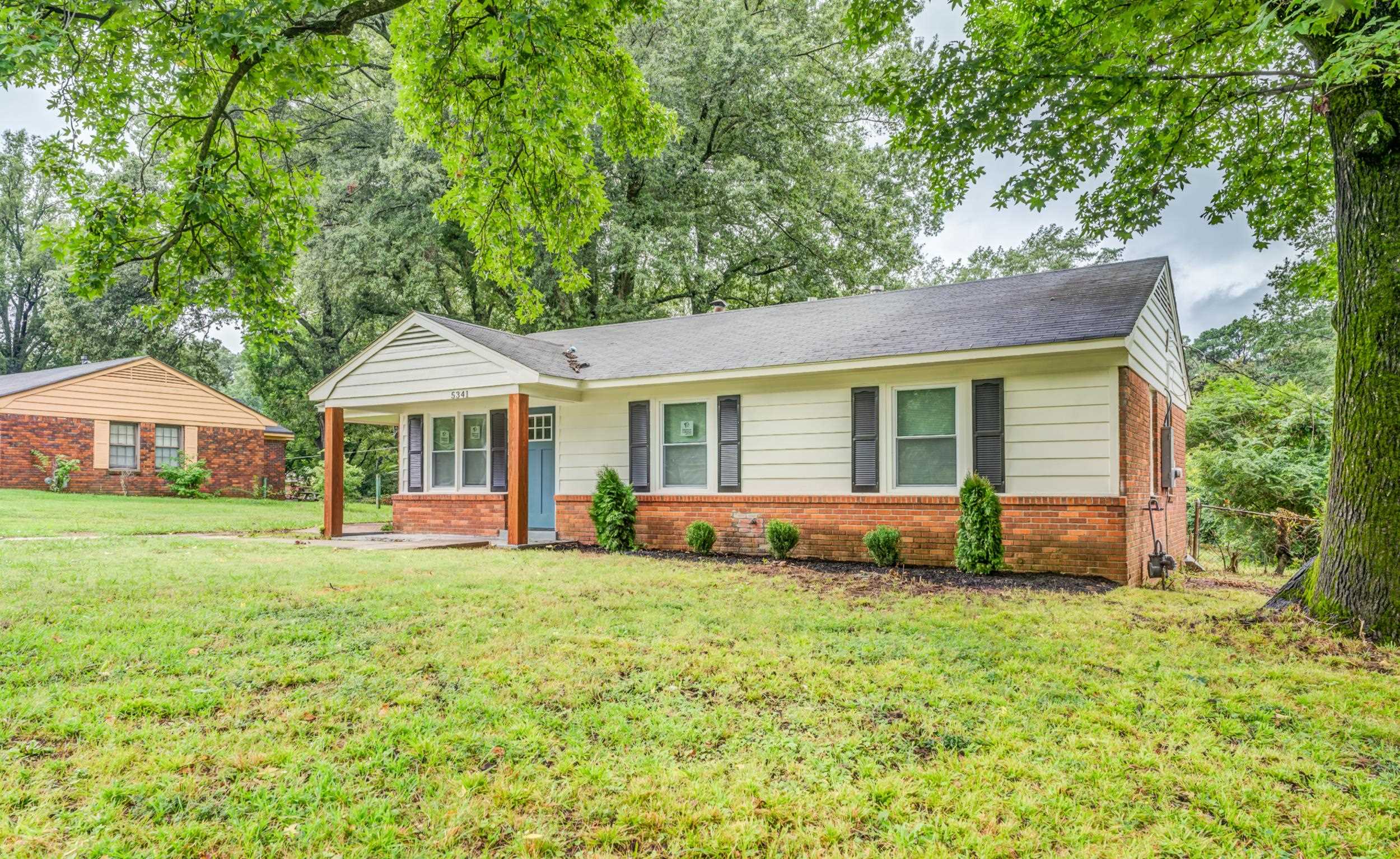 5341 Millbranch Road Memphis, TN 38116 - Photo 3 of 29 a view of a house with a yard and sitting area