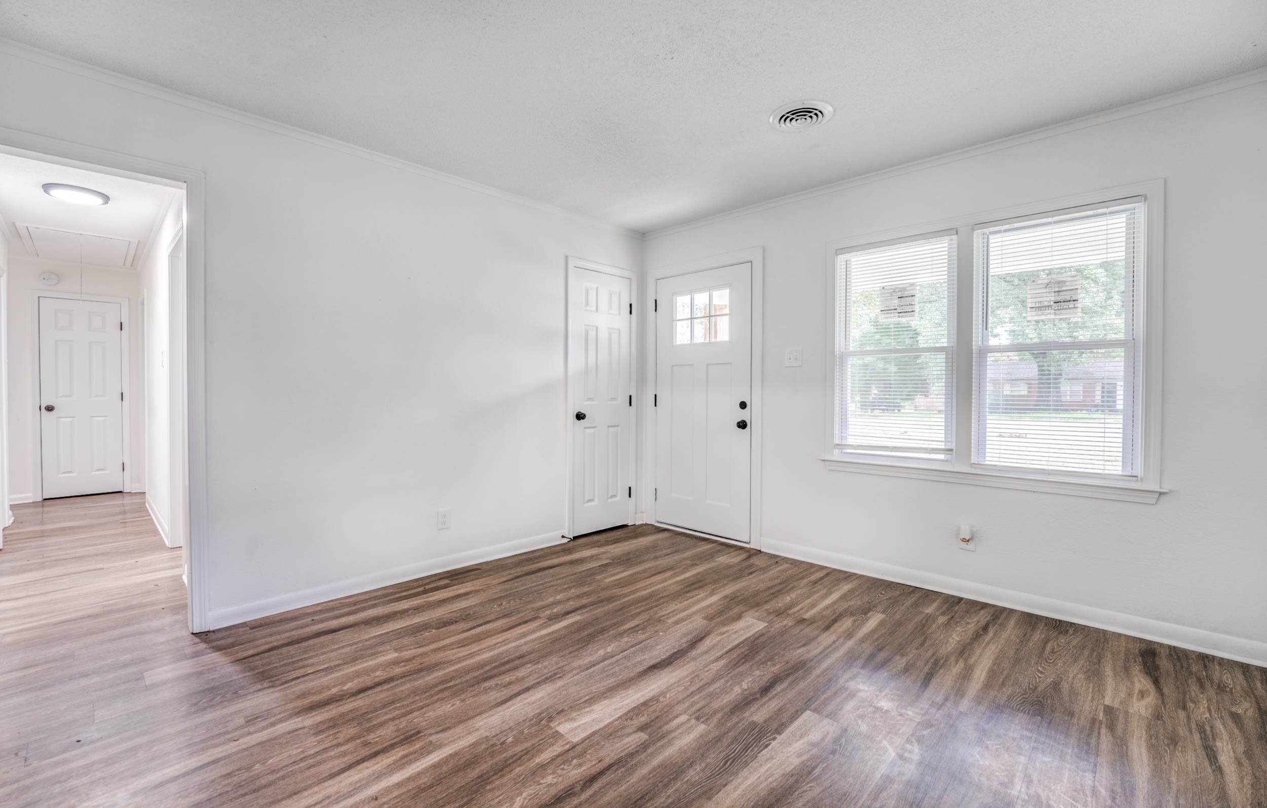 5341 Millbranch Road Memphis, TN 38116 - Photo 6 of 29 a view of empty room with wooden floor and fan