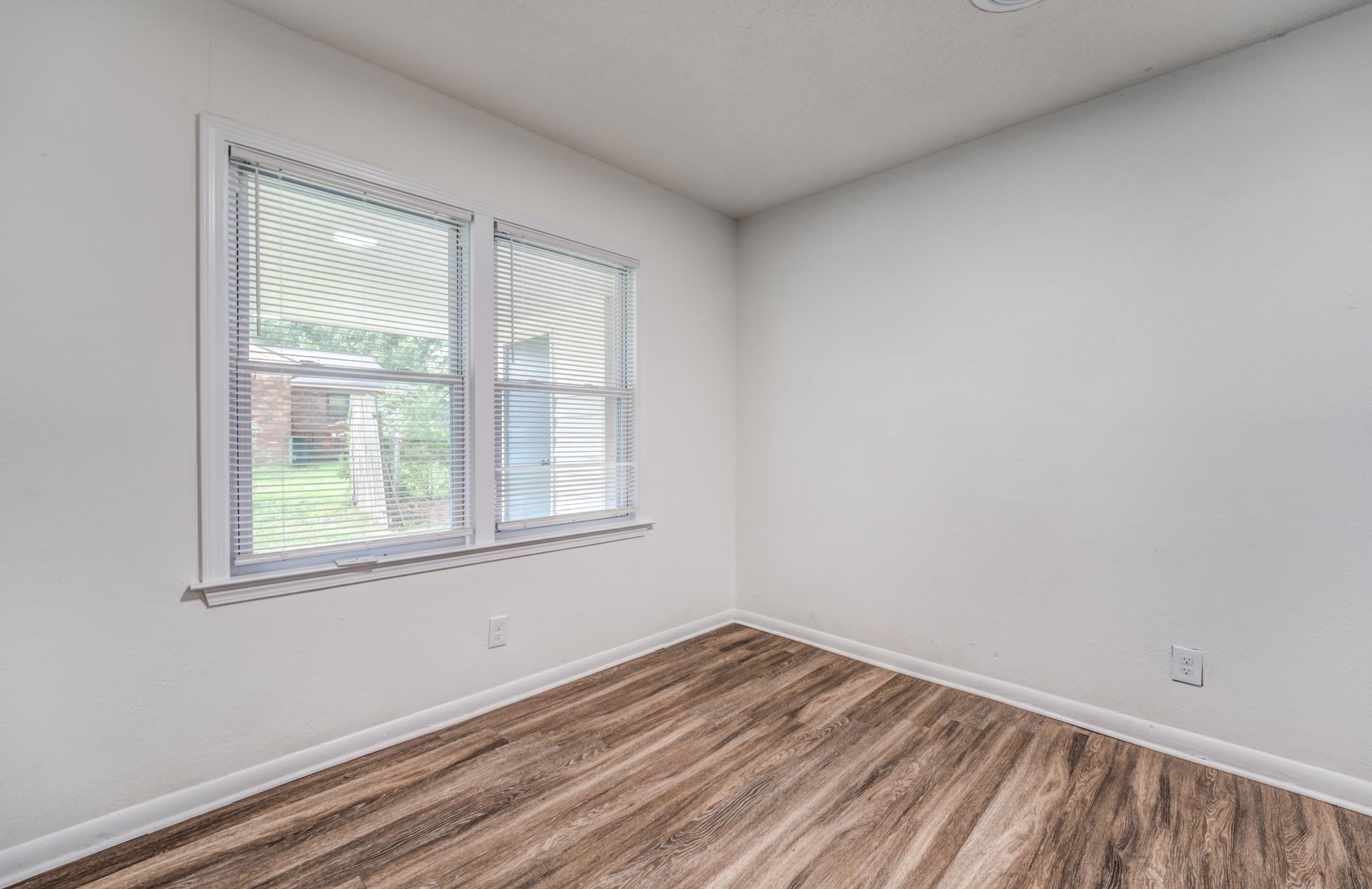 5341 Millbranch Road Memphis, TN 38116 - Photo 8 of 29 an empty room with a window