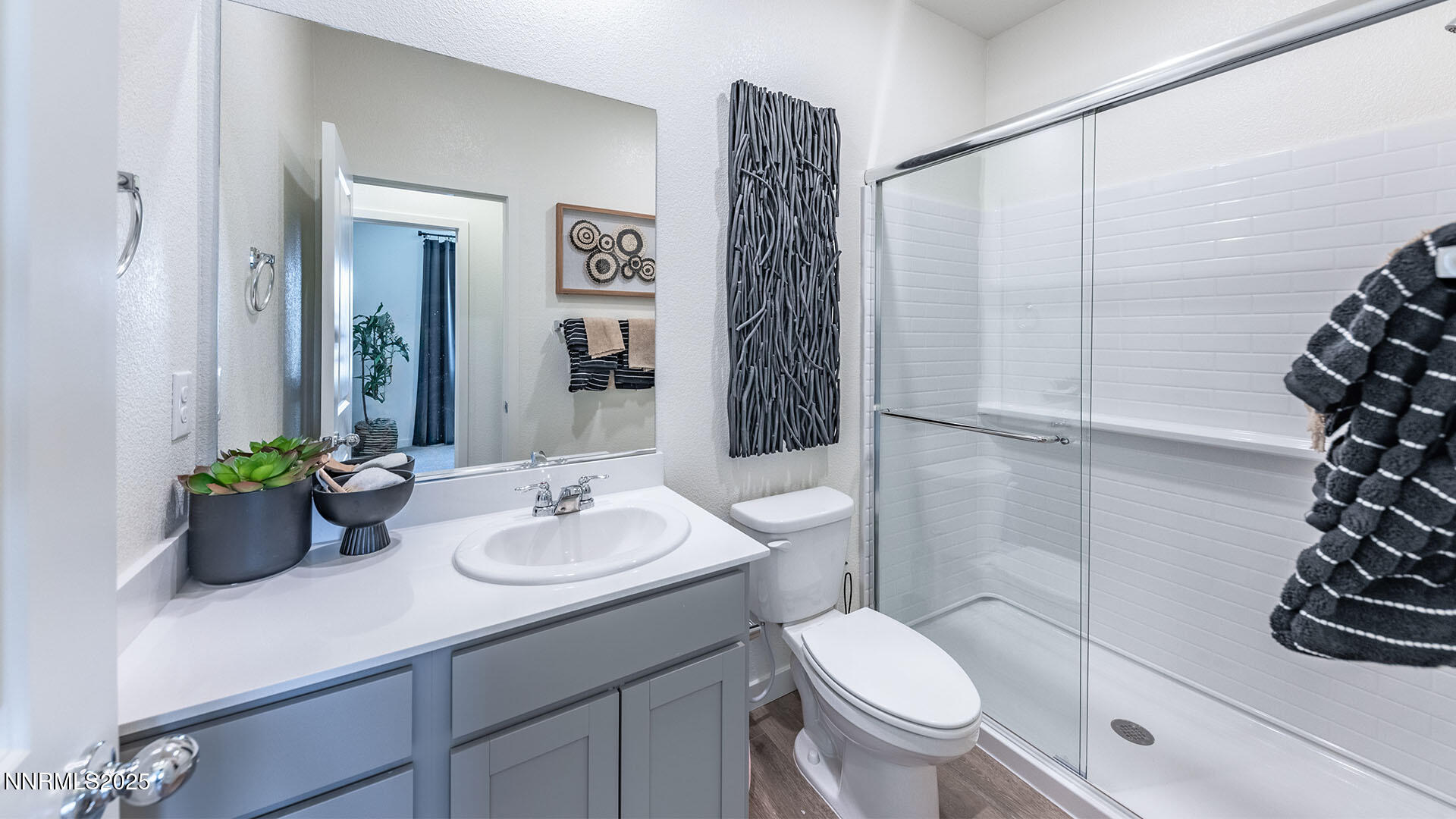 7489 Capstone Drive Reno, NV 89506 - Photo 24 of 25 a bathroom with a sink a toilet and shower