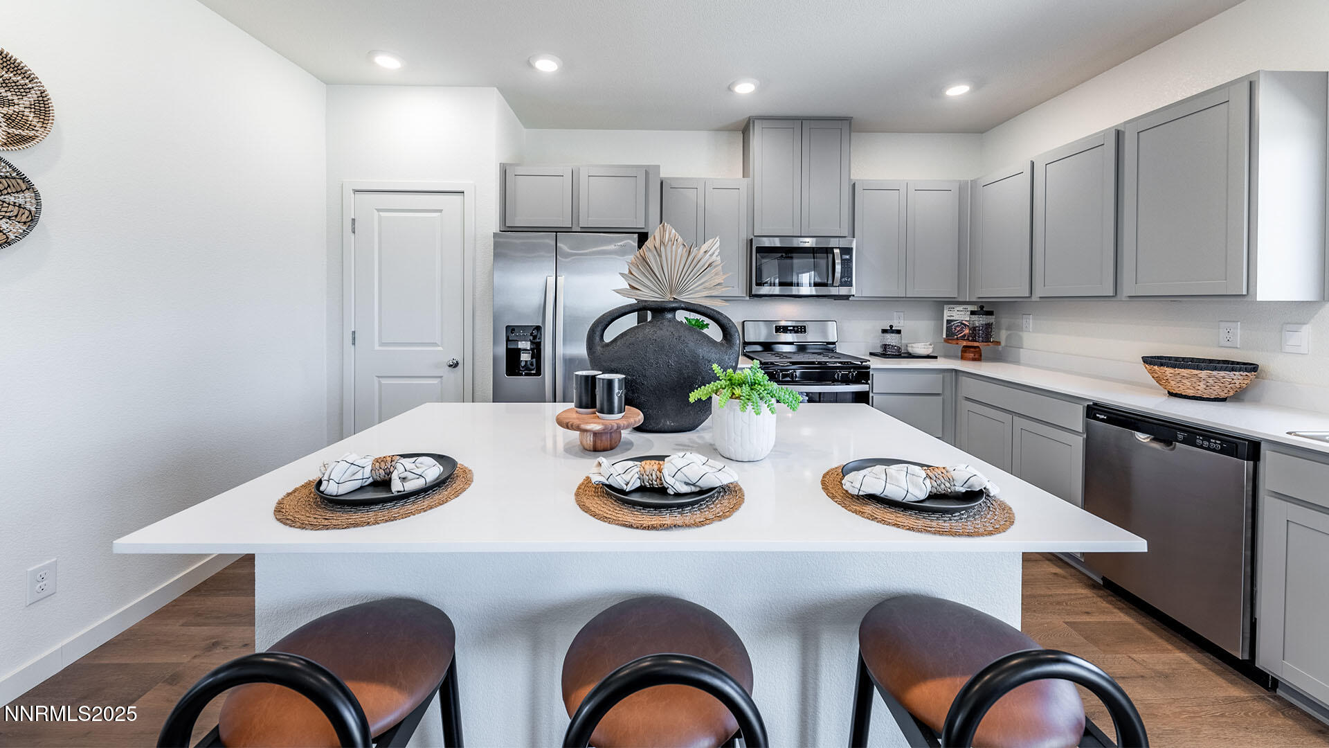 7489 Capstone Drive Reno, NV 89506 - Photo 8 of 25 a kitchen with a refrigerator a stove a sink and chairs