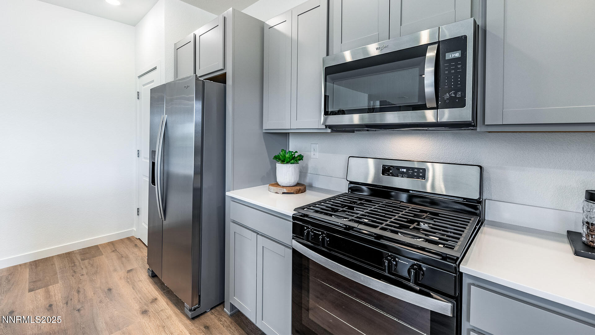7489 Capstone Drive Reno, NV 89506 - Photo 9 of 25 a kitchen with stainless steel appliances granite countertop a stove a microwave and a refrigerator