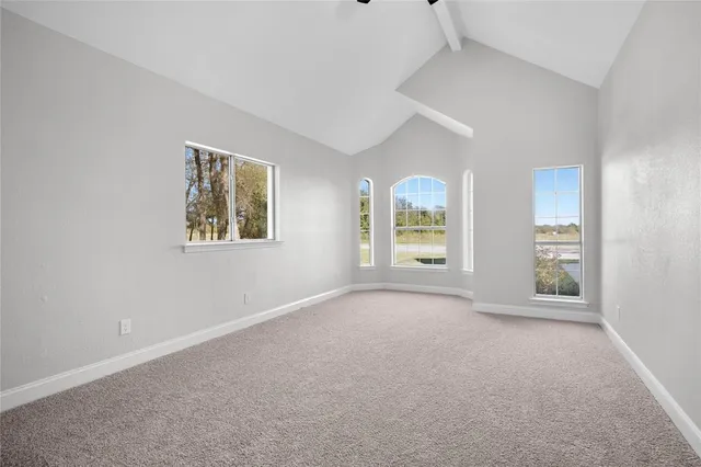 a large kitchen with kitchen island a stove a sink dishwasher and a oven with white cabinets