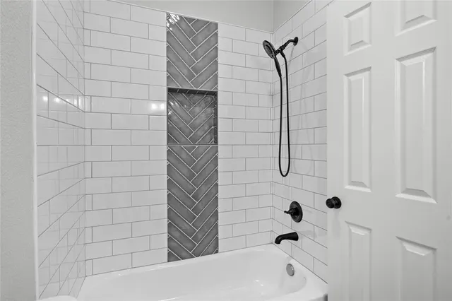 a white bath tub sitting next to a shower