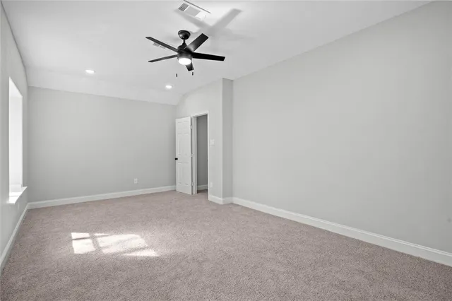 a bathroom with a granite countertop toilet sink and mirror