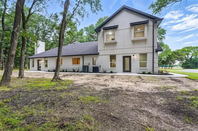 an empty room with window and ceiling fan