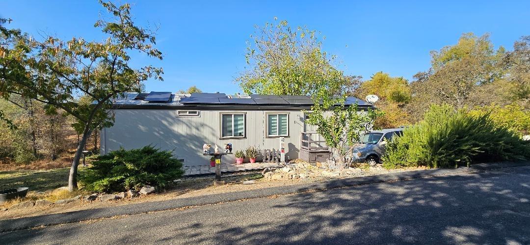a view of a house with a tree in the background