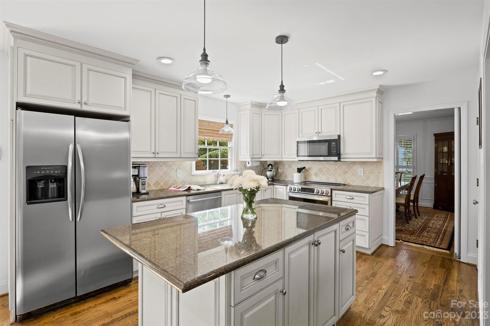 5943 Brace Road Charlotte, NC 28211 - Photo 12 of 36 a kitchen with stainless steel appliances granite countertop a sink a stove a refrigerator and cabinets