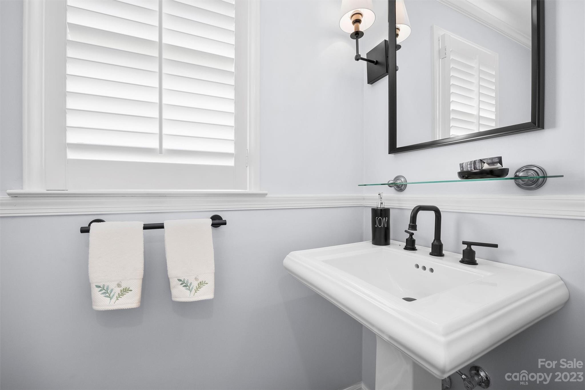 5943 Brace Road Charlotte, NC 28211 - Photo 14 of 36 a bathroom with a sink and a mirror