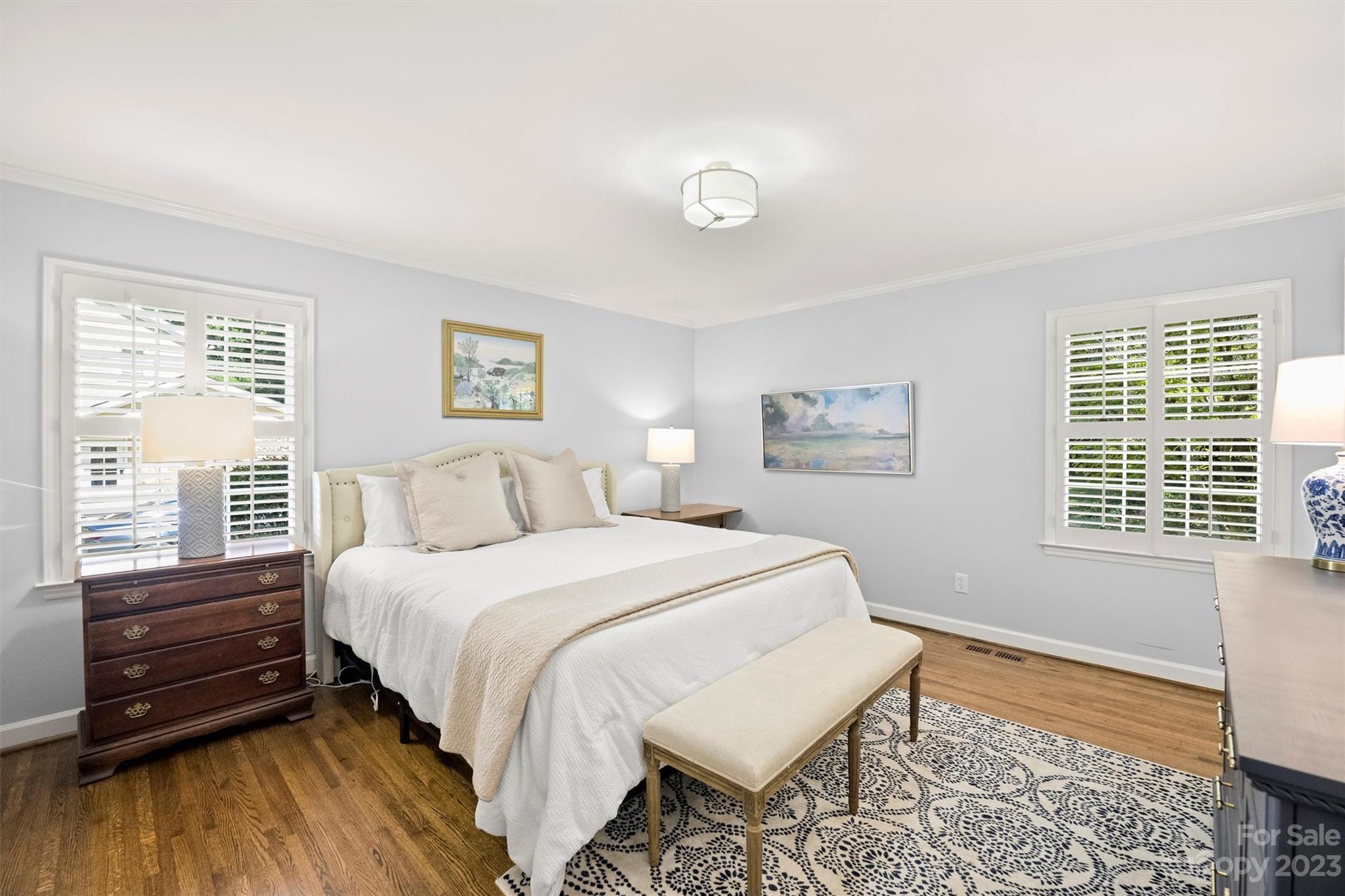 5943 Brace Road Charlotte, NC 28211 - Photo 23 of 36 a bedroom with a bed and a dresser next to a window