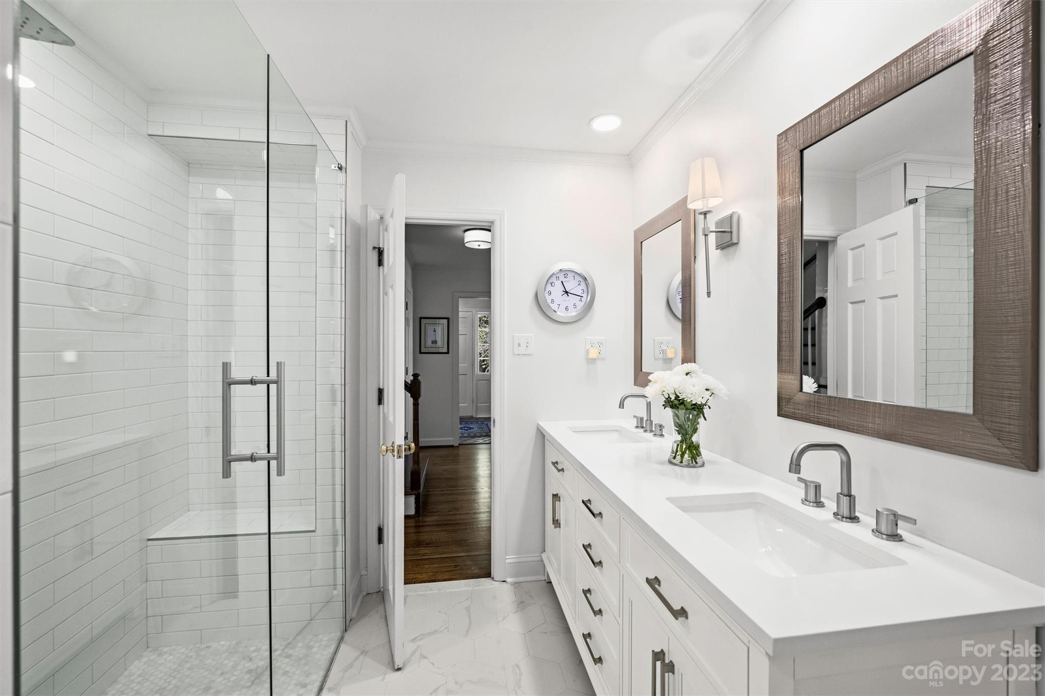5943 Brace Road Charlotte, NC 28211 - Photo 26 of 36 a bathroom with a double vanity sink mirror and shower