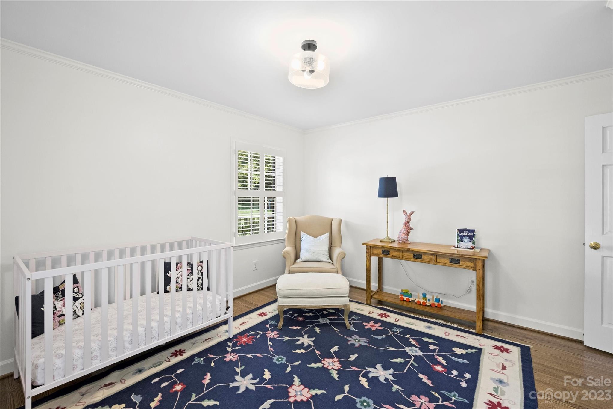 5943 Brace Road Charlotte, NC 28211 - Photo 27 of 36 a living room with furniture and a baby crib