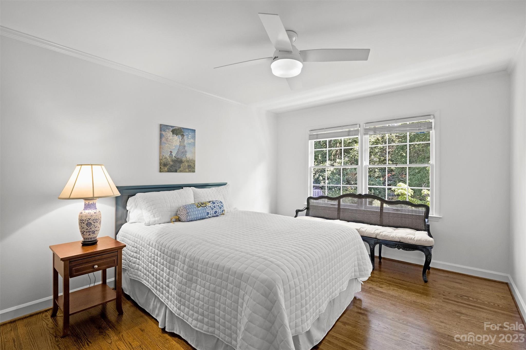 5943 Brace Road Charlotte, NC 28211 - Photo 30 of 36 a bedroom with a bed a lamp and a large window