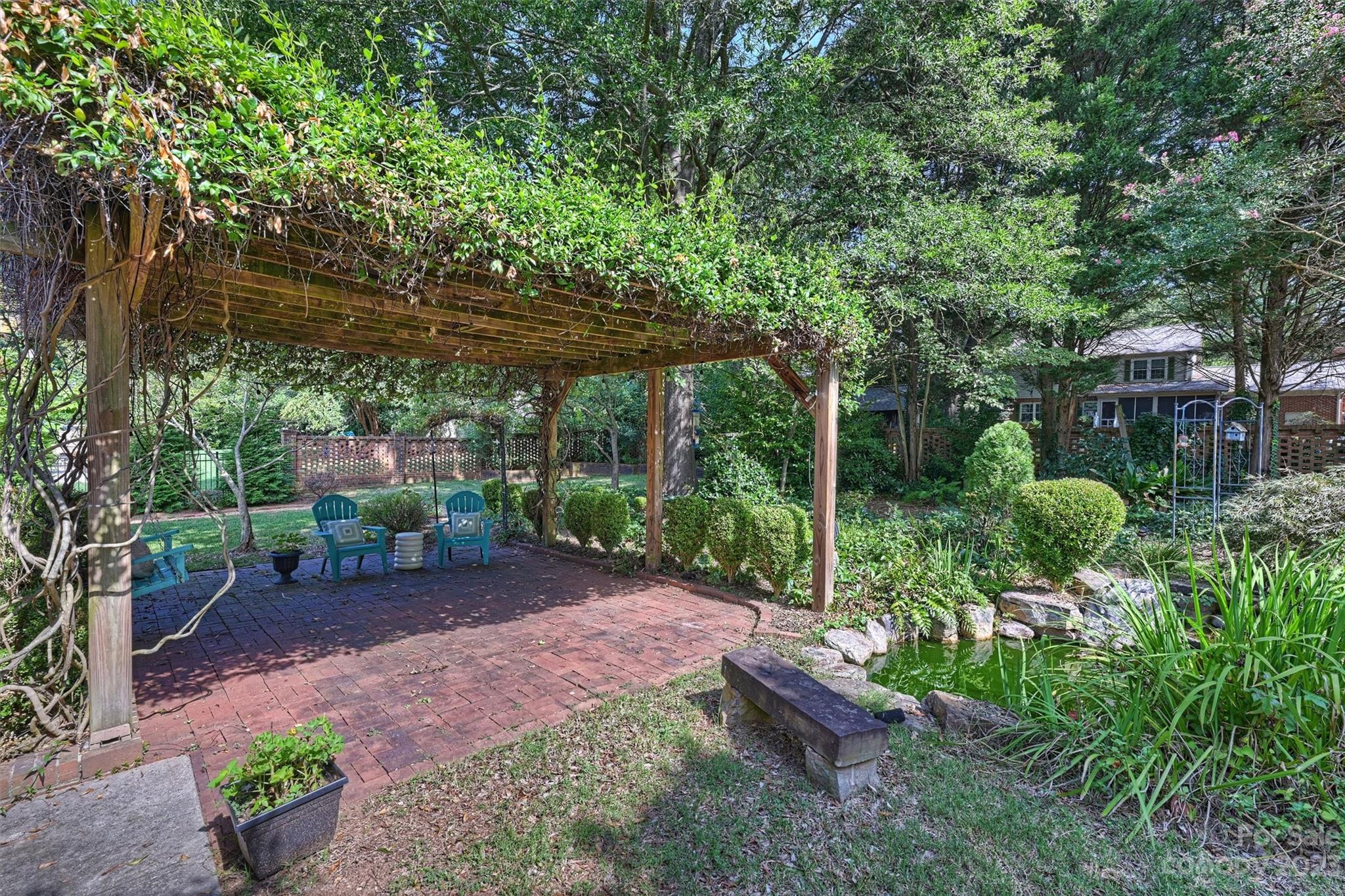 5943 Brace Road Charlotte, NC 28211 - Photo 32 of 36 a view of a backyard with plants and large trees