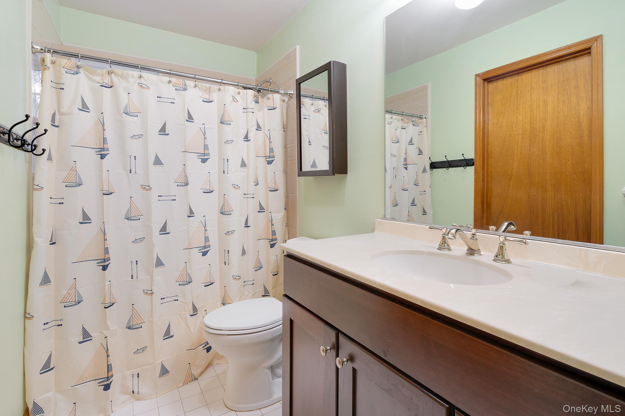 1 Mountain View Road Fishkill, NY 12524 - Photo 17 of 35 a bathroom with a sink a toilet and shower curtain
