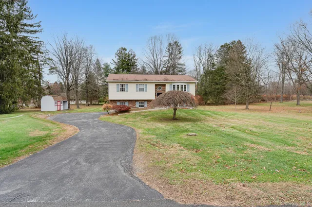 a front view of house with yard and trees